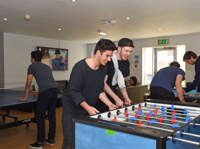 Students playing table games in common room