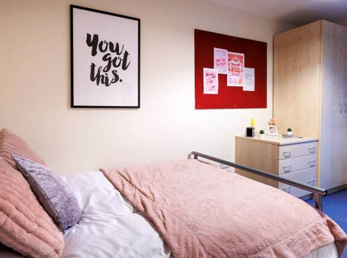 Student bedroom with bed, desk and chair