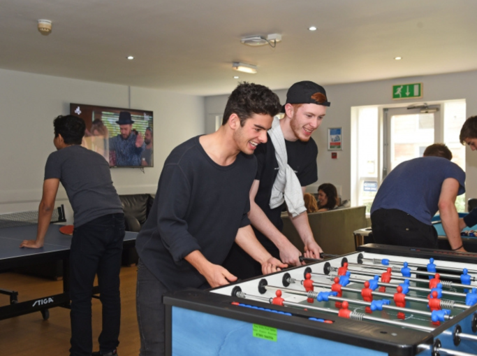 Students playing table games in common room