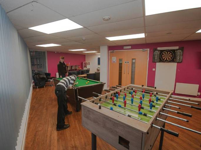 Students playing pool in common room