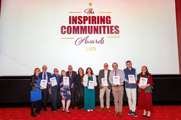 Group stood together smiling with awards and certificates
