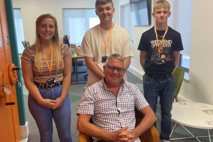 Three apprentices stood behind the chief executive