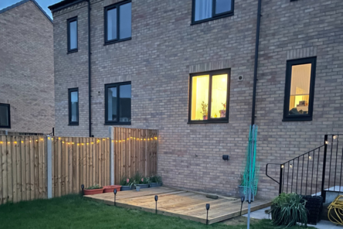 Garden and a house with solar lights at twilight