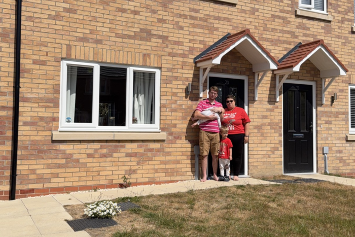 A family outside their shared ownership home bought through Acis Group