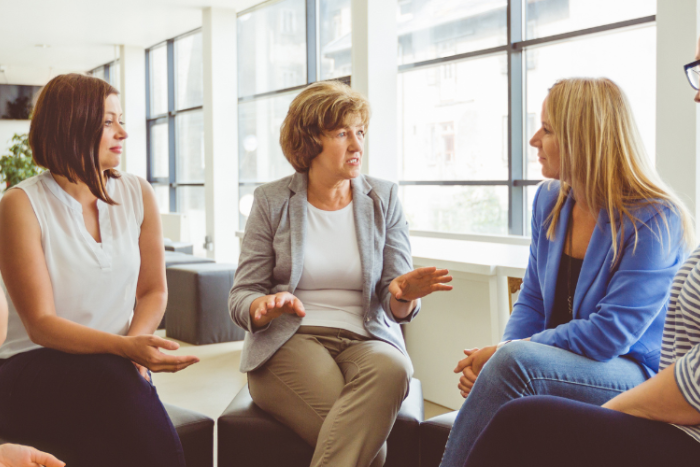 A group of people sat in a circle chatting