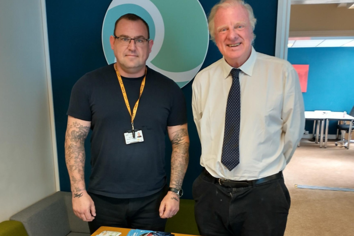 Two men stood smiling