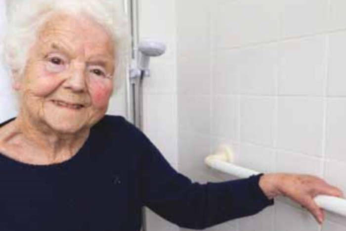 Elderly woman infront of shower