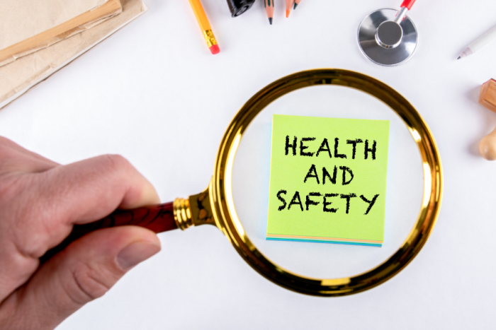 A magnifying glass looking closely at the words health and safety