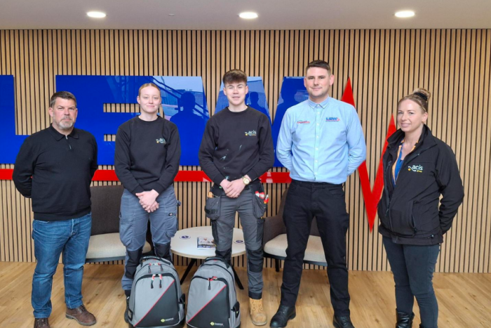 Acis Group and Lew Employees stood in front of the LEW sign at the LEW office in Gainsborough