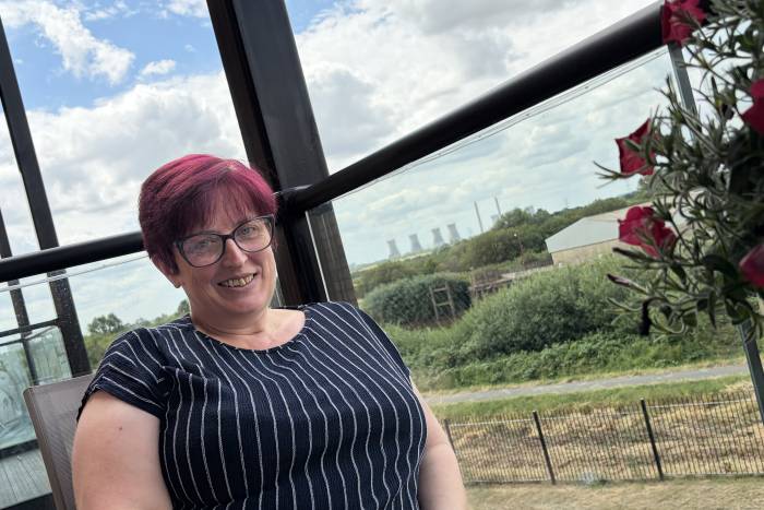 Marie on the balcony of her new Acis home in Gainsborough