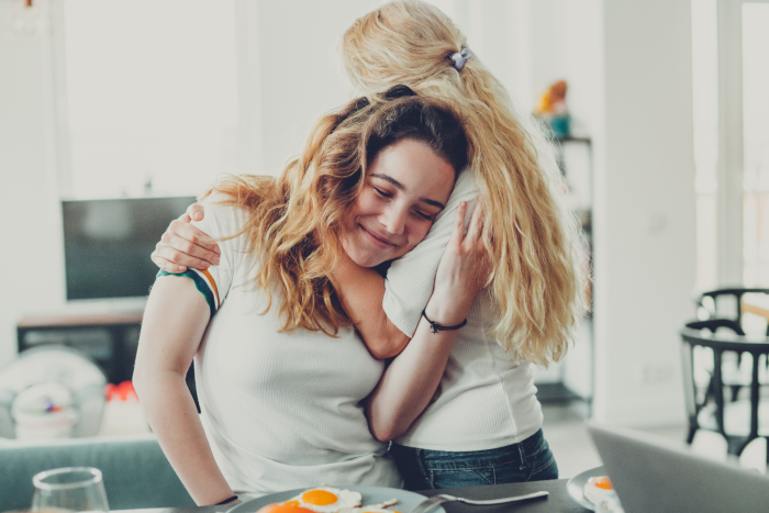 Parent hugging a child