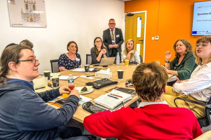 A group of people sat discussing