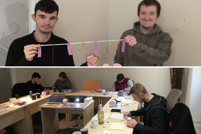 Young people sitting at desks writing