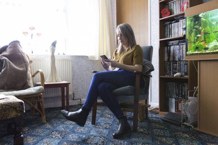 Woman on the phone sat in a living room