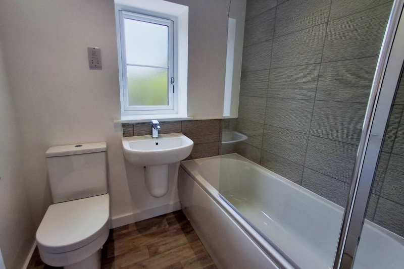 The bathroom showing toilet, sink, bath and shower
