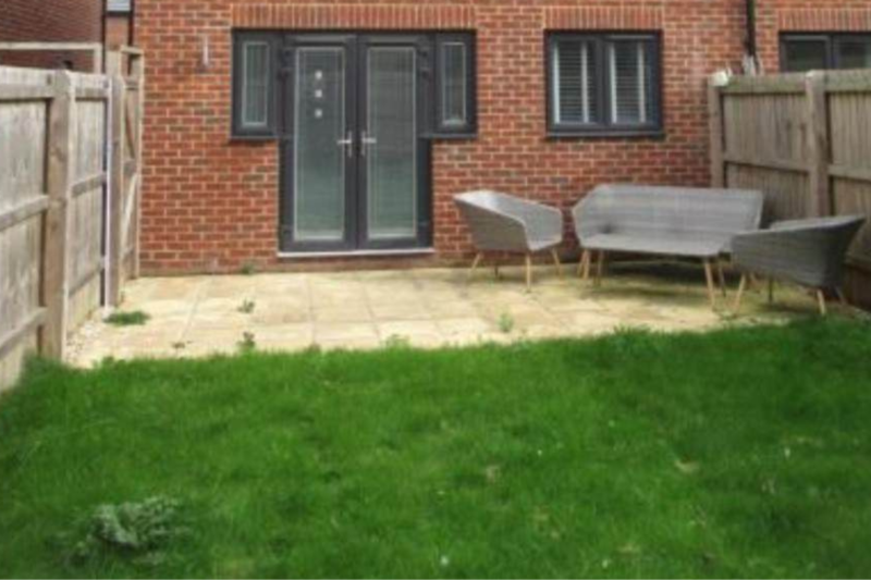 Rear elevation with patio and lawn