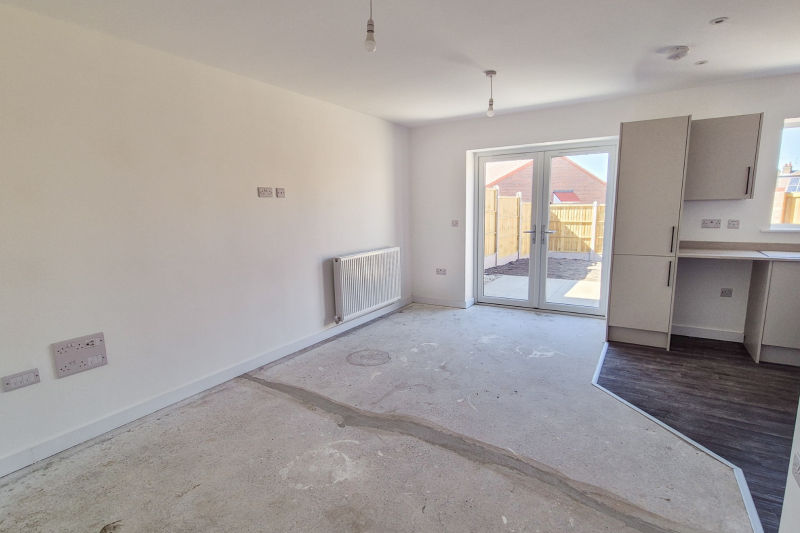 Dining and living space with patio doors out to the garden