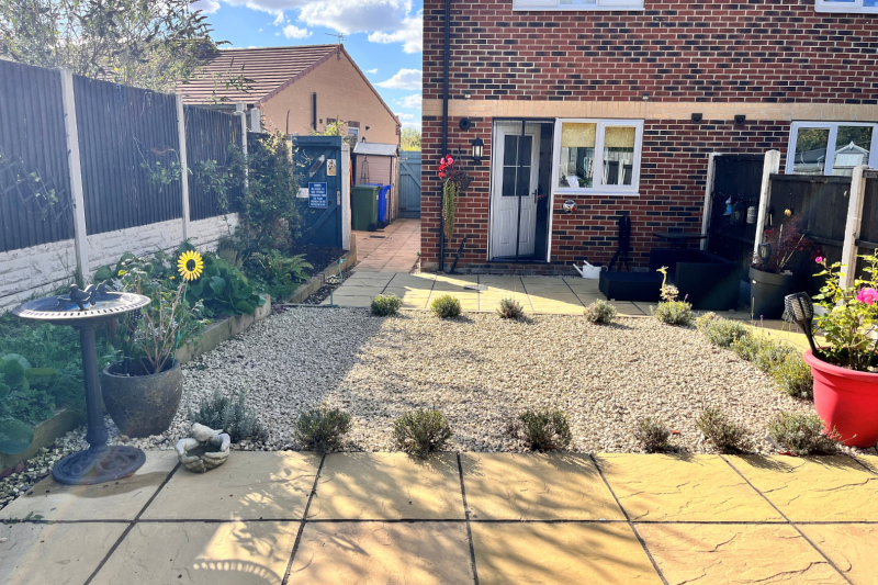 Gravel garden looking towards the back of a house