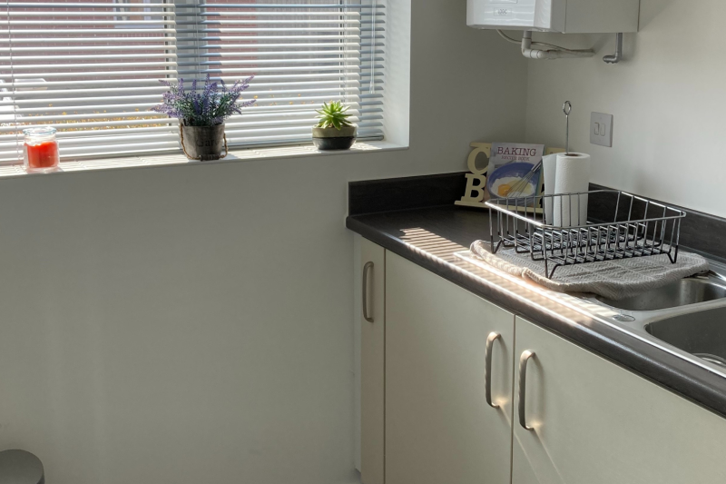 A photo of the kitchen showing the sink and window