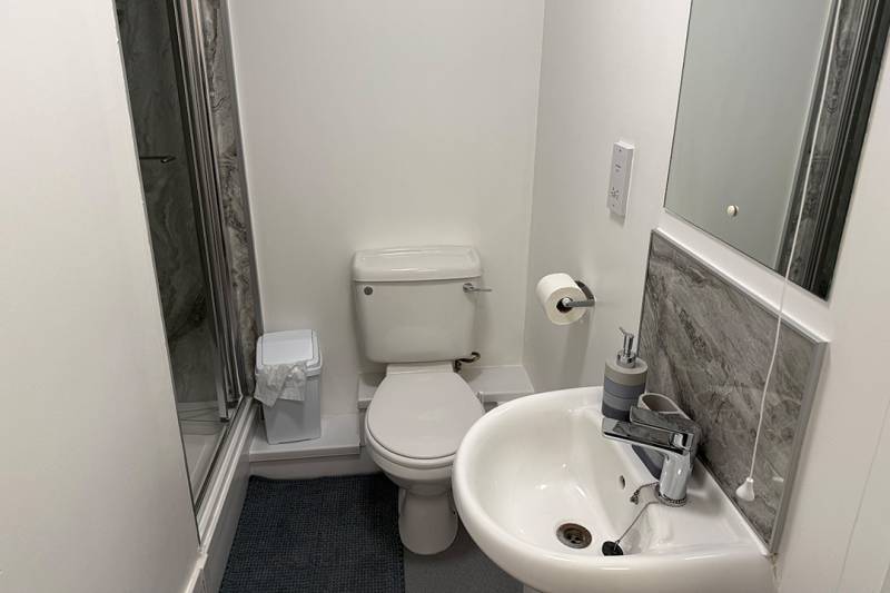 Ensuite bathroom with shower, sink and toilet