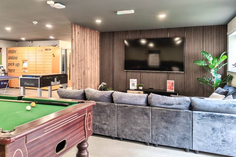Common room with large flat screen TV and sofas