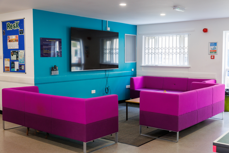 Student common room with large flat screen TV and sofas