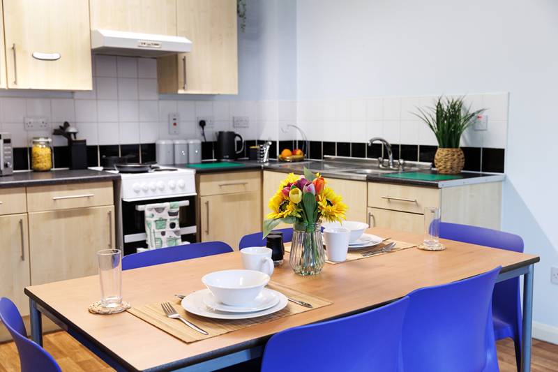 Single room type kitchen with table and chairs