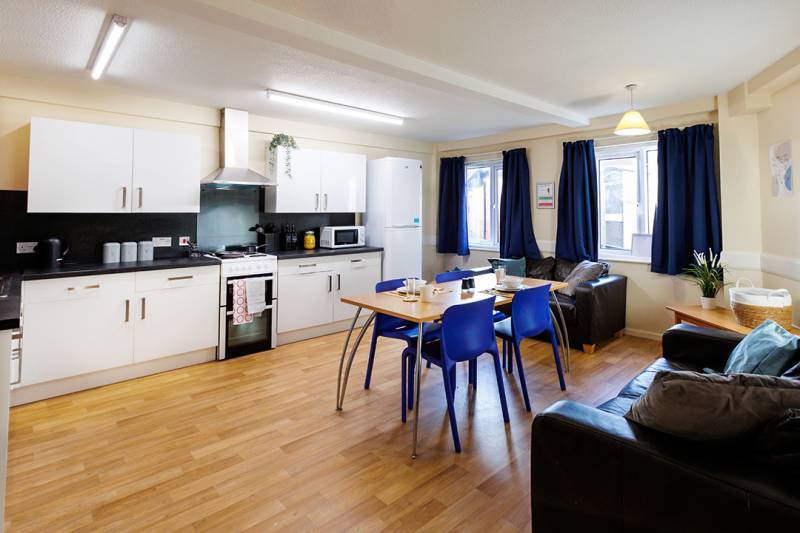 Large student kitchen with dining table and chairs