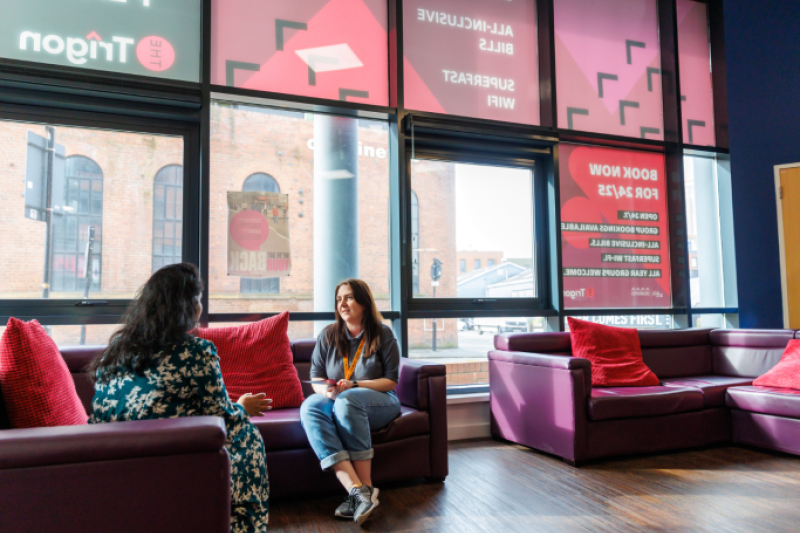 Reception area with two students chatting