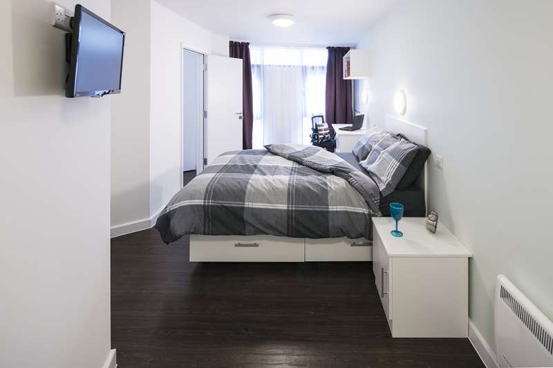 Bedroom with bed and television on the wall