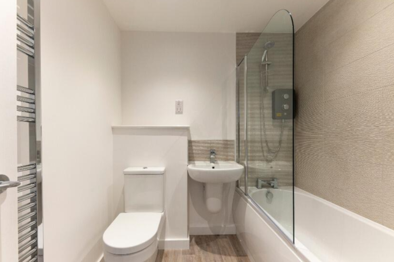 Upstairs bathroom showing toilet, sink, and shower