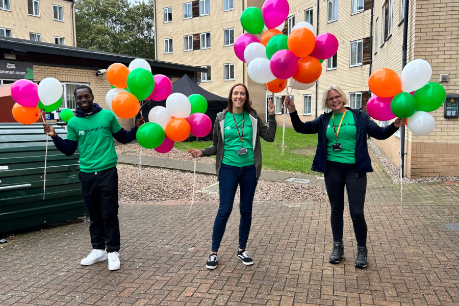 three people in green tshirts at the raleigh park move-in