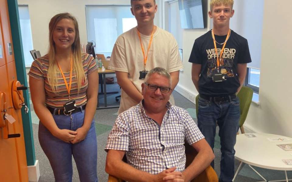 Three apprentices stood behind the chief executive