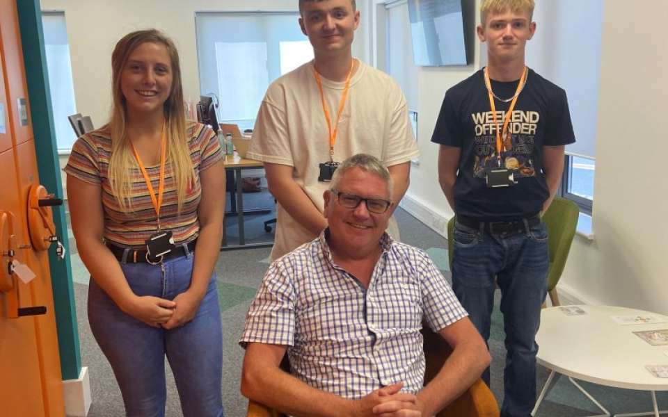 Three apprentices stood behind the chief executive