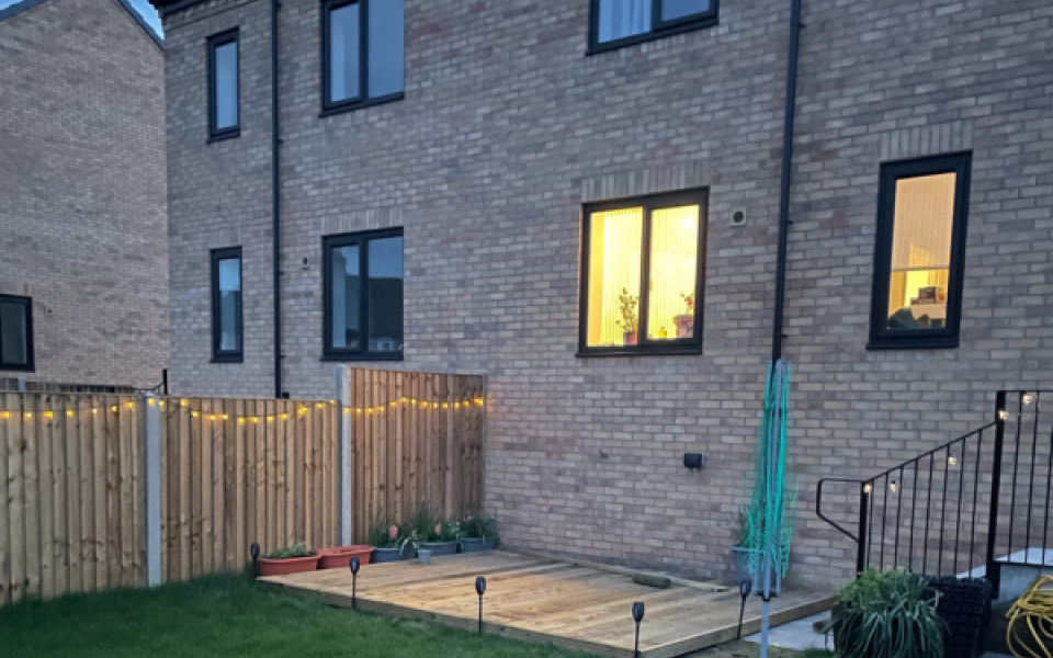 Garden and a house with solar lights at twilight