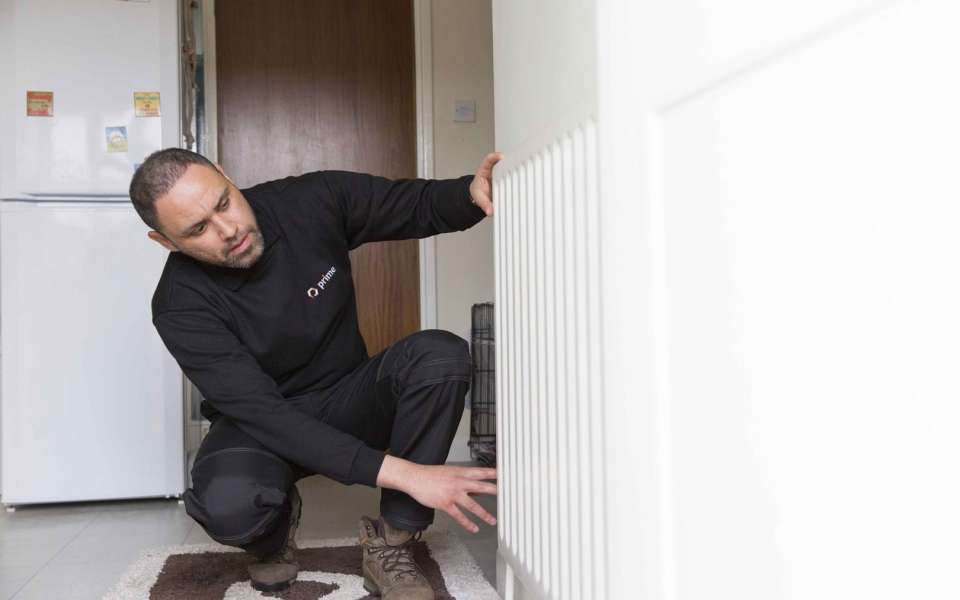 Handyperson examining radiator