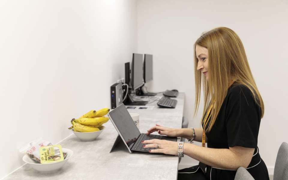 Person sitting at a desk with a laptop computer