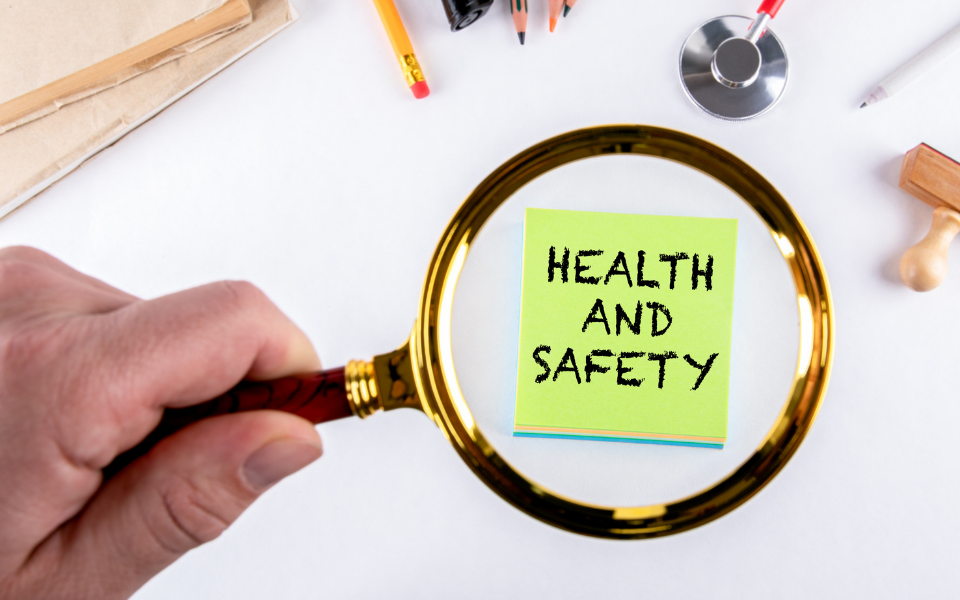 A magnifying glass looking closely at the words health and safety