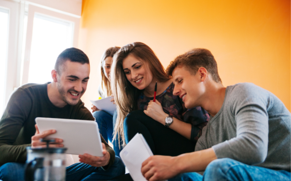 Students looking at a tablet