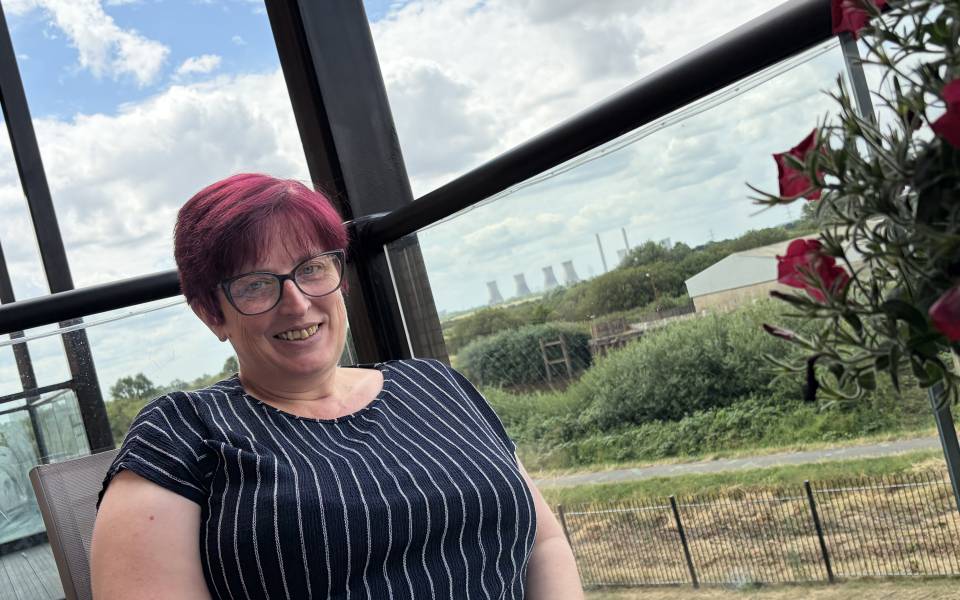 Marie on the balcony of her new Acis home in Gainsborough