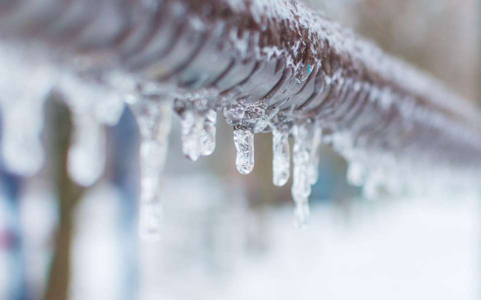 Close up of pipe with ice dropping off it