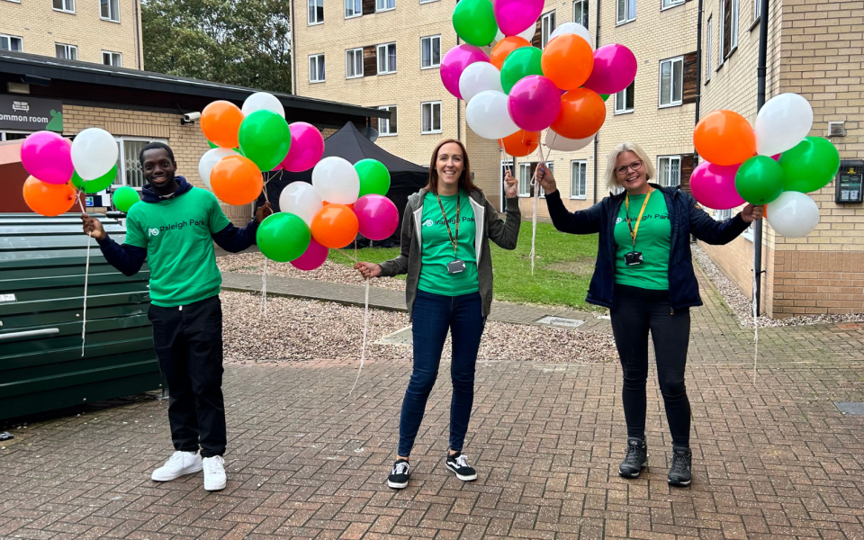 three people in green tshirts at the raleigh park move-in