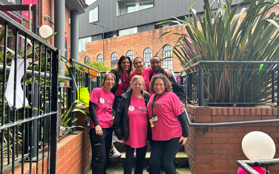 six people in pink tshirts at the trigon move-in event 