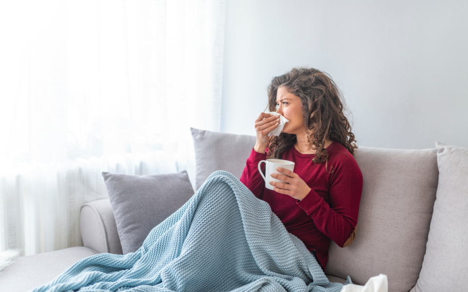 A person on the sofa seemingly unwell 