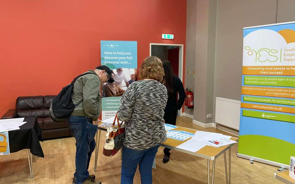 Two people looking at leaflets